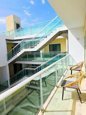 a staircase in a building with a chair at Feeling Santa Maria in Santa Maria