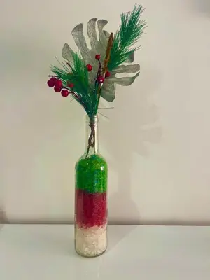a glass bottle with a plant in it at Encanto do Mar in Santa Maria
