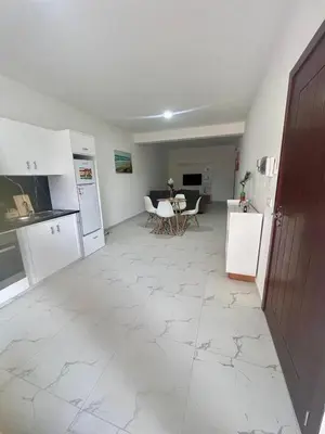a kitchen with white appliances and a table with chairs at Encanto do Mar in Santa Maria