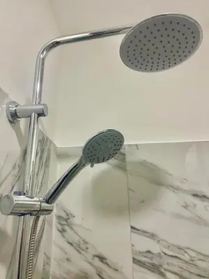 a shower with a shower head in a bathroom at Encanto do Mar in Santa Maria