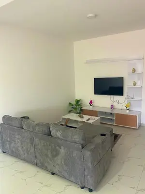 a living room with a couch and a flat screen tv at Encanto do Mar in Santa Maria