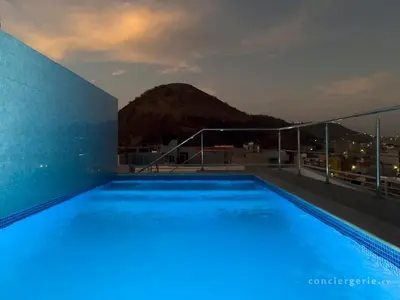 a swimming pool on the roof of a building at 2 bdr aprt, stunning view, rooftop pool - LCGR in Praia