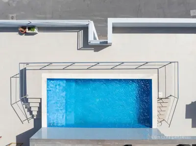 a person standing next to a swimming pool at 2 bdr aprt, stunning view, rooftop pool - LCGR in Praia