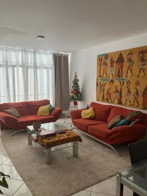 a living room with two red couches and a christmas tree at AkyaSpot in Praia