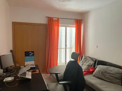a living room with a desk with a computer on it at AkyaSpot in Praia