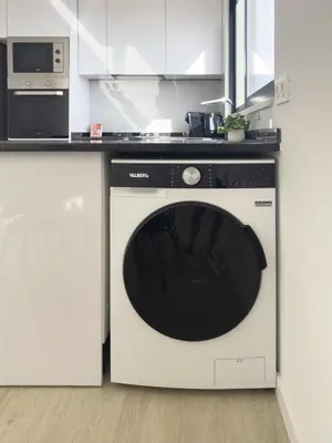 a kitchen with a black and white dishwasher at Spacious 2 bdr aprt, rooftop pool - LCGR in Praia