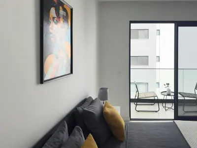 a living room with a couch and a picture on the wall at Spacious 2 bdr aprt, rooftop pool - LCGR in Praia