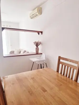a dining room with a table and chairs and a mirror at Apart T2 em frente à Praia - Centro de Santa Maria in Santa Maria
