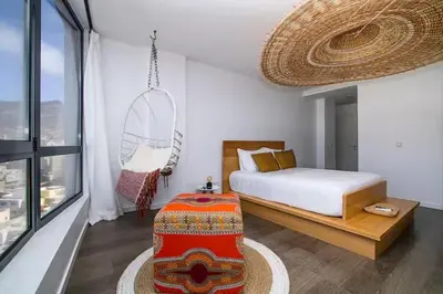a bedroom with a bed and a large window at Mindelo Sunset Ocean Views near Laginha Beach in Mindelo