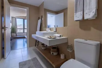 a bathroom with a white sink and a toilet at Mindelo Sunset Ocean Views near Laginha Beach in Mindelo