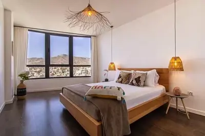 a bedroom with a large bed and a large window at Mindelo Sunset Ocean Views near Laginha Beach in Mindelo