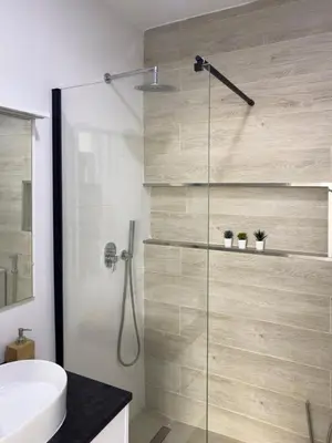a bathroom with a shower and a toilet and a sink at Cozy 2 bdr aprt, rooftop pool - LCGR in Praia