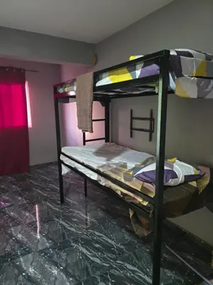 a bedroom with two bunk beds in a room at Mtechempire hostel in Espargos