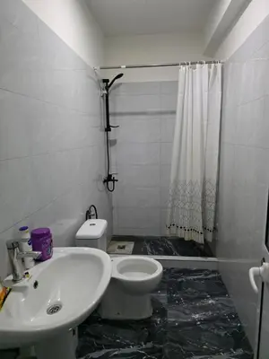 a bathroom with a white toilet and a sink at Mtechempire hostel in Espargos