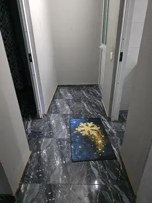 a hallway with a marble floor in a room at Mtechempire hostel in Espargos