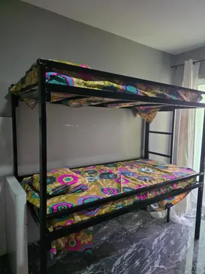a bedroom with two bunk beds in a room at Mtechempire hostel in Espargos