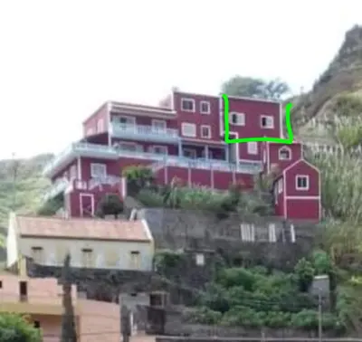 a house on a hill with a green arrow at I love TANK in Caculi