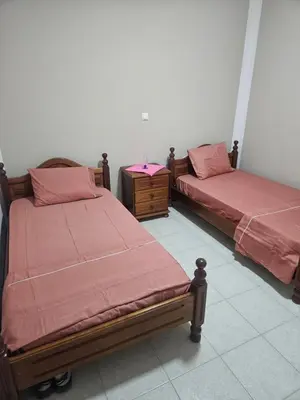 two beds with red sheets in a room at I love TANK in Caculi