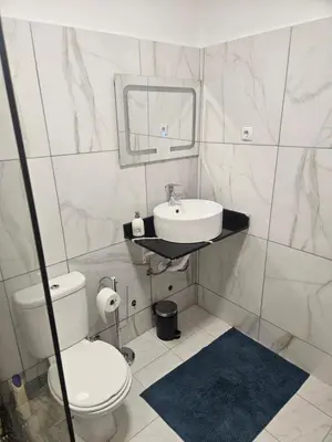 a bathroom with a sink and a toilet and a mirror at I love TANK in Caculi