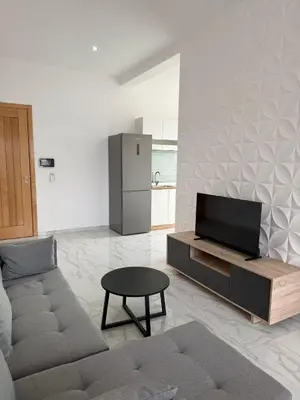 a living room with a couch and a tv at AQUÁRIO Hotel in Sal Rei