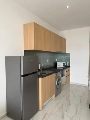 a kitchen with a stainless steel refrigerator and a dishwasher at AQUÁRIO Hotel in Sal Rei