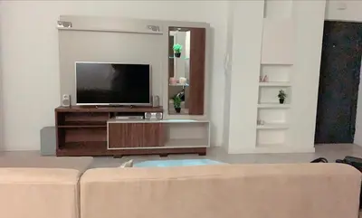 a living room with a couch and a flat screen tv at HAC Apto in Praia