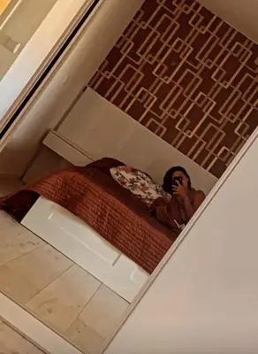 a picture of a man sitting on a bed at HAC Apto in Praia