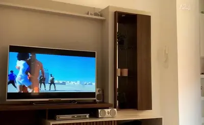 a flat screen tv sitting in a living room at HAC Apto in Praia