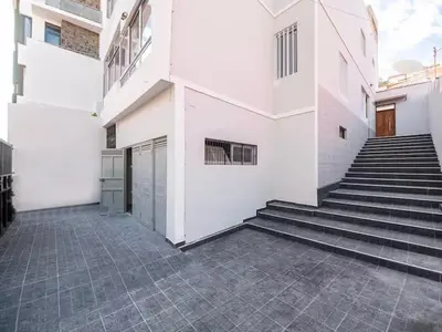 a white building with stairs in front of it at Casa Evora - Your home away from home in Mindelo