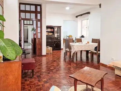 a living room with a table and a dining room at Casa Evora - Your home away from home in Mindelo