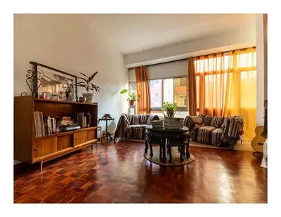 a living room with a table and a couch at Casa Evora - Your home away from home in Mindelo