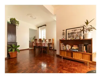 a living room with a table and a book shelf at Casa Evora - Your home away from home in Mindelo