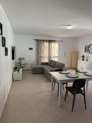 a living room with a table and a couch at Estrela do Sul Santa Maria by RPG Group in Santa Maria