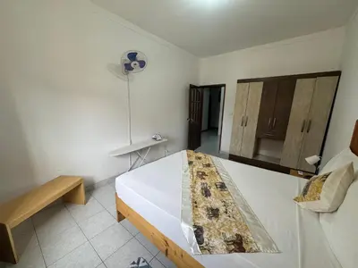 a bedroom with a large white bed in a room at Legacy cv in Praia