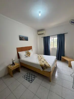 a bedroom with a bed and a window at Legacy cv in Praia