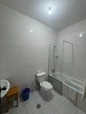 a bathroom with a toilet and a tub and a sink at Legacy cv in Praia