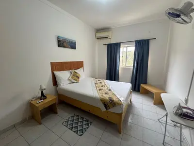 a bedroom with a bed and a window at Legacy cv in Praia