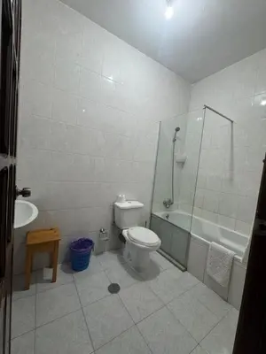 a bathroom with a toilet and a tub and a sink at Legacy cv in Praia