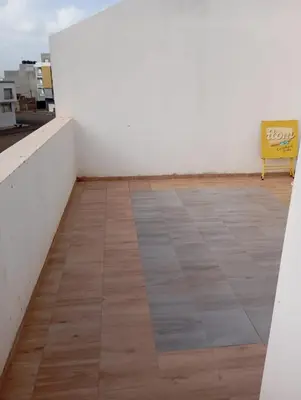 a yellow bench sitting on top of a white wall at Ti Jona Rooms in Mindelo