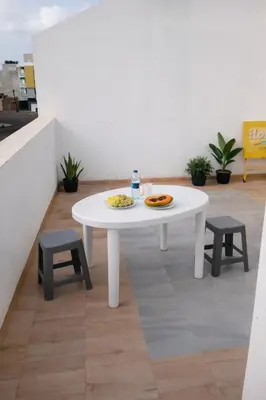 a white table with a plate of food on it at Ti Jona Rooms in Mindelo
