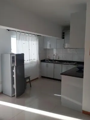 a white kitchen with a sink and a refrigerator at Ti Jona Rooms in Mindelo