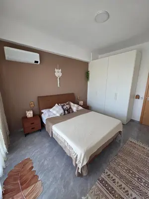 a bedroom with a bed and a cross on the wall at The Zen Den in Sal Rei