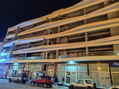 a building with cars parked outside of it at night at The Zen Den in Sal Rei