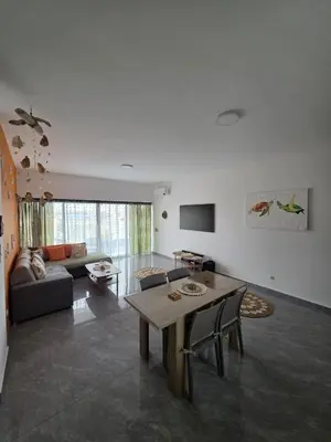 a living room with a table and a couch at The Zen Den in Sal Rei