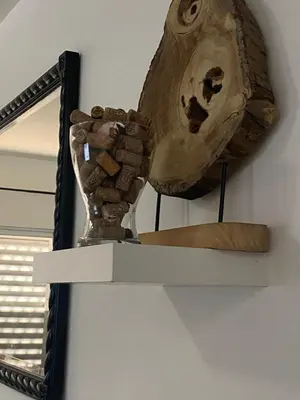 a mirror on a wall with a skull on a shelf at Coraçon di Mindel Apartment in Mindelo