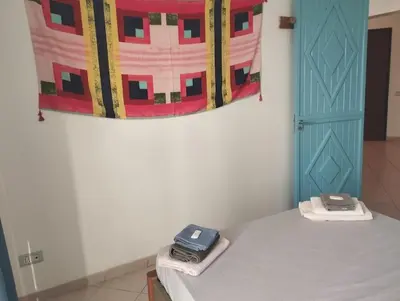 a room with a bed and a painting on the wall at Holiday Properties Ca' Meli - Wi-fi in Santa Maria