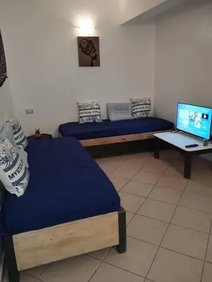 a room with two beds and a desk with a laptop at Holiday Properties Ca' Meli - Wi-fi in Santa Maria