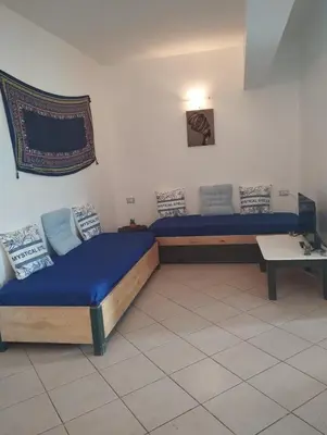 a room with two beds and a table at Holiday Properties Ca' Meli - Wi-fi in Santa Maria