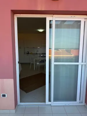 a sliding glass door leading into a kitchen at Apartament POR DO SOL A9 praia Cabral wi-fi free Sal Rei in Sal Rei