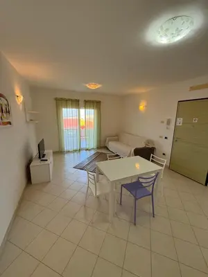 a living room with a table and a couch at Apartament POR DO SOL A9 praia Cabral wi-fi free Sal Rei in Sal Rei